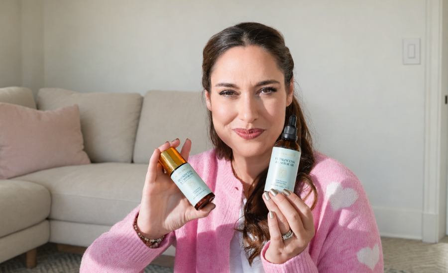 Holistic Goddess Founder holding Frankincense & Castor Oil Roller and dropper