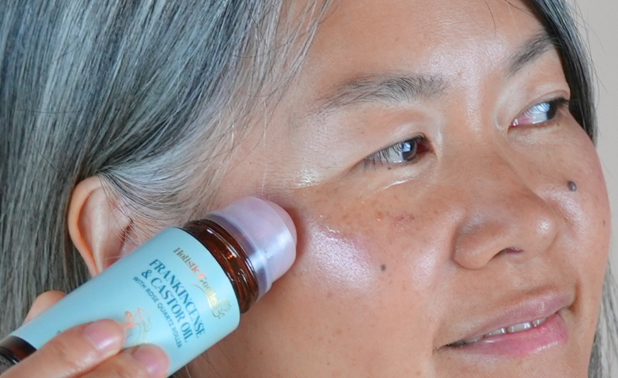 Women Applying frankincense & Castor oil under eyes