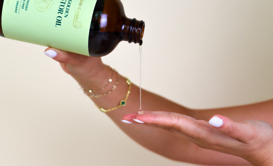 Organic castor oil being poured onto hand