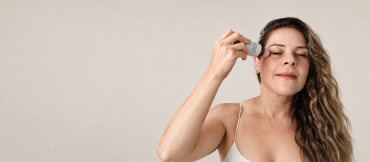 Holistic Goddess Frankincense & Castor Oil roll-on being applied around the eye area