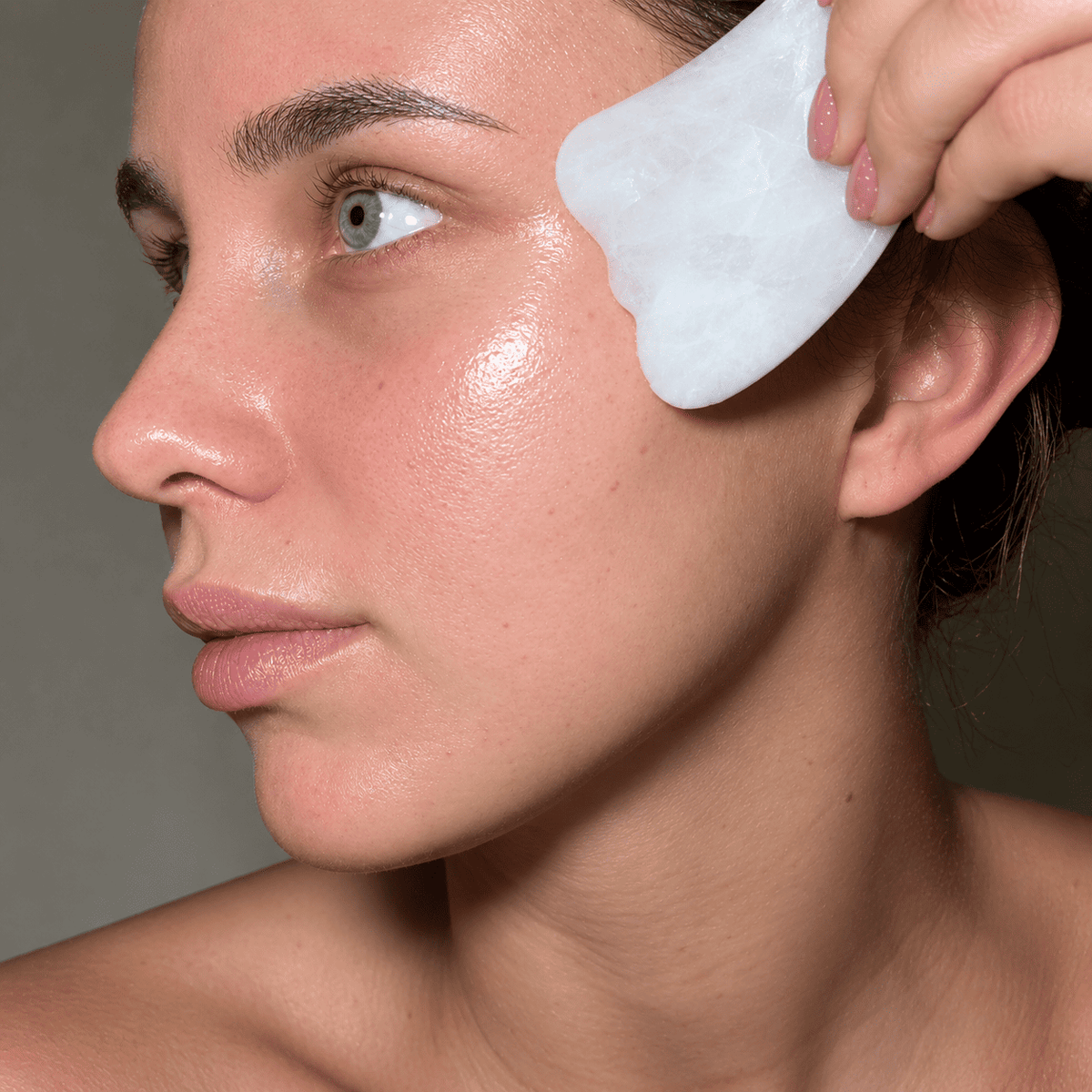 Frankincense Gua Sha Contour Kit by Holistic Goddess – how-to-use step 3, sculpt: gliding gua sha along jaw and cheeks