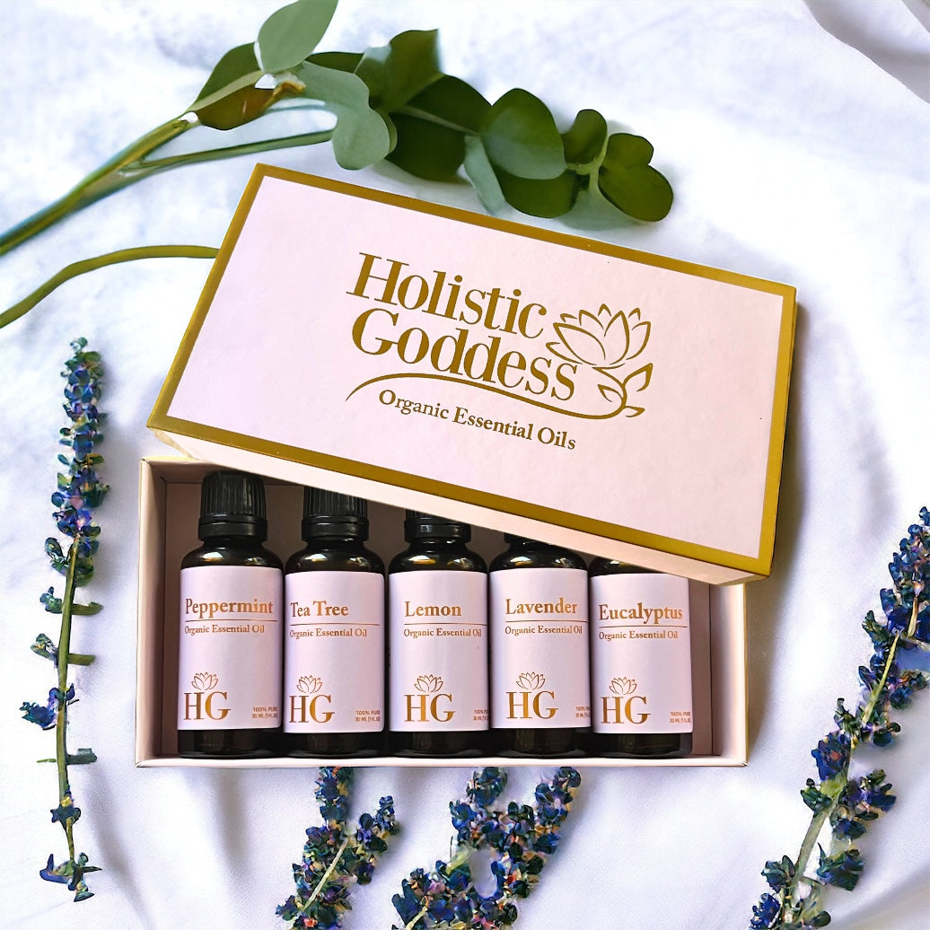 Open gift box with five organic essential oils: peppermint, tea tree, lemon, lavender, and eucalyptus, with sprigs