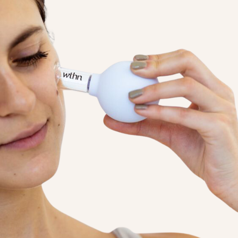 Face Cupping Kit by wthn – woman using face cup on cheek 2