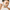 Bentonite Volcanic Clay by Yareli Wellness – woman applying clay mask with brush, looking in mirror